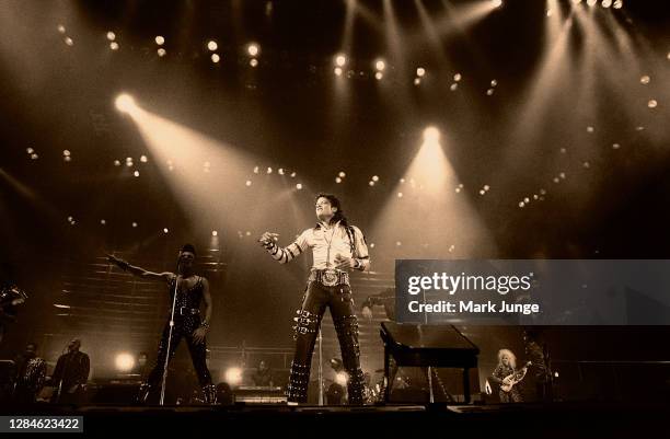 Michael Jackson performs during a "Bad Tour" concert at McNichols Arena on March 24, 1988 in Denver, Colorado. The image has been tinted by the...