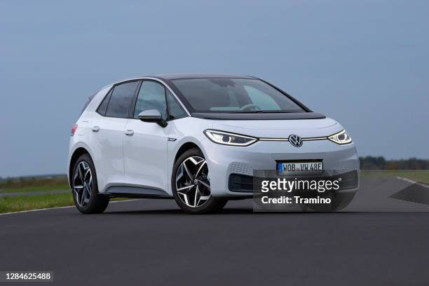 electric car volkswagen id.3 on a road - volkswagen stock pictures, royalty-free photos & images