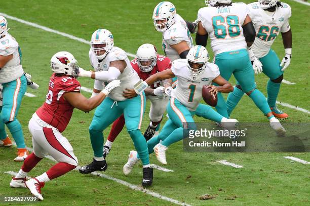 Tua Tagovailoa of the Miami Dolphins runs with the ball during the first half against the Arizona Cardinals at State Farm Stadium on November 08,...