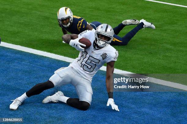 Nelson Agholor of the Las Vegas Raiders makes a third quarter touchdown catch in front Nasir Adderley of the Los Angeles Chargers of at SoFi Stadium...