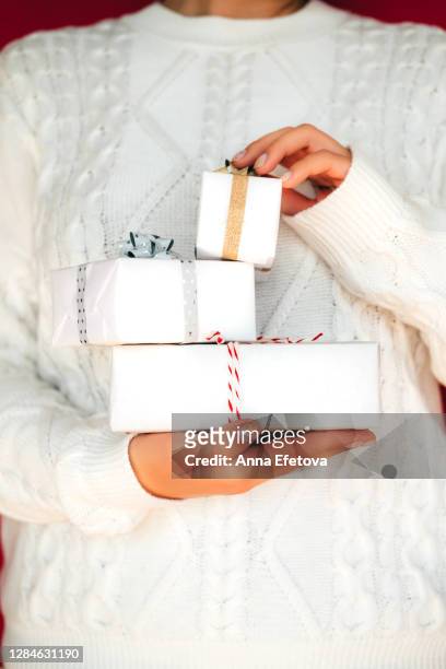 unrecognizable female with stack of christmas gifts - pile of gifts stock pictures, royalty-free photos & images