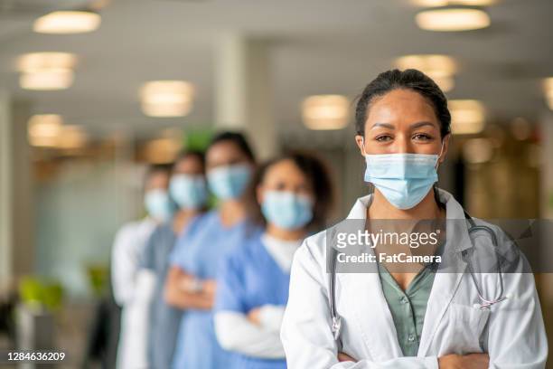 healthcare workers portrait - female doctor with mask stock pictures, royalty-free photos & images