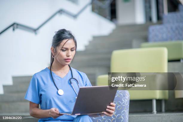 medical professional working on computer - nurse thinking stock pictures, royalty-free photos & images