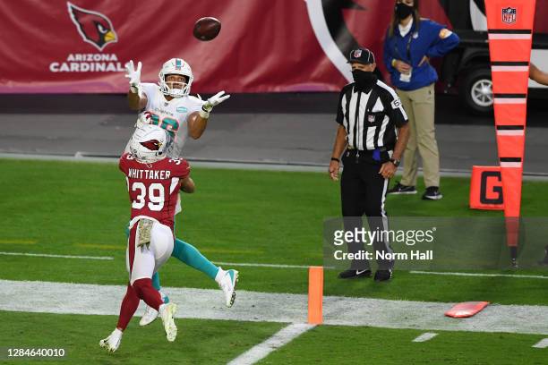 Mack Hollins of the Miami Dolphins catches a touchdown pass as Jace Whittaker of the Arizona Cardinals defends during the second half at State Farm...