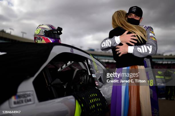 Jimmie Johnson, driver of the Ally Chevrolet, and wife Chandra Johnson embrace prior to the NASCAR Cup Series Season Finale 500 at Phoenix Raceway on...