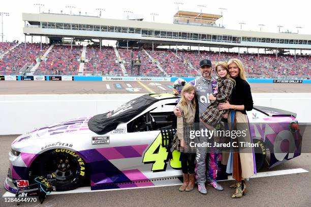 Jimmie Johnson, driver of the Ally Chevrolet, poses on the grid with his wife Chandra Johnson and their daughters Lydia Norriss Johnson and Genevieve...