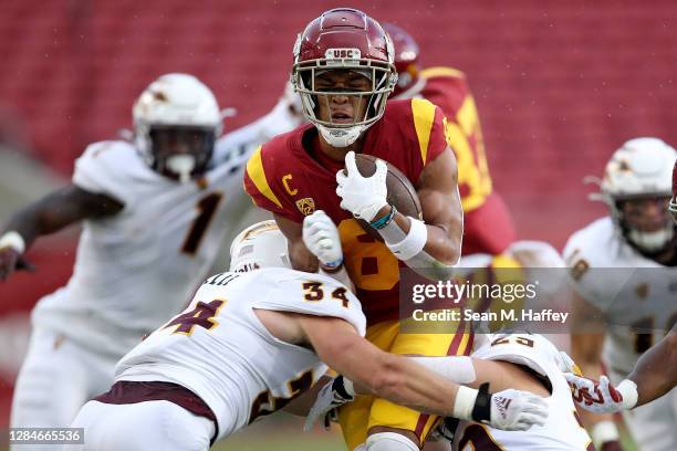 Kyle Soelle of the Arizona State Sun Devils tackles Amon-Ra St. Brown of the USC Trojans during the first half of a game at Los Angeles Coliseum on...