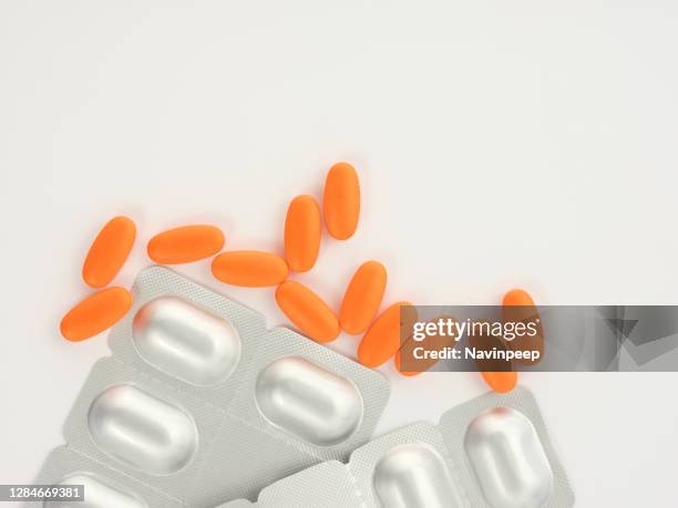 orange medicine and silver color capsule package on white background - vitamin sachet stock pictures, royalty-free photos & images