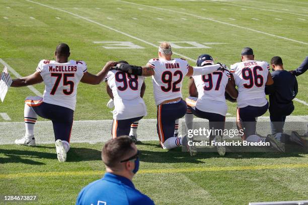 Dan McCullers, Bilal Nichols, Brent Urban, Mario Edwards, and Akiem Hicks of the Chicago Bears kneel during the national anthem prior to against the...