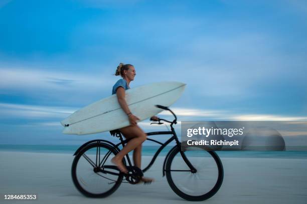 Surfboard Riding Surfboard Riding Bicycle Photos and Premium High Res Pictures - Getty ...