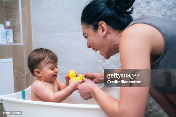 mother and baby bath time - taking a bath stock pictures, royalty-free photos & images