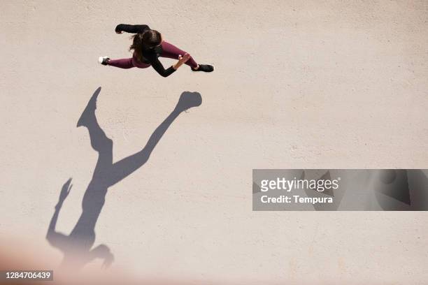 top view of a woman running with copy space. - running stock pictures, royalty-free photos & images