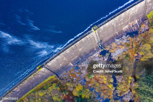 the high angle aerial view of a dam on a scottish loch in dumfries and galloway south west scotland - hydroelectric power stock pictures, royalty-free photos & images