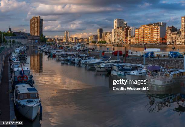 belgium,liege province,liege, rows of boats moored along city canal at dusk - liege stockfoto's en -beelden