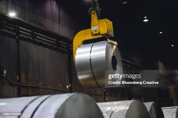 rolls of steel sheet - roll up stockfoto's en -beelden