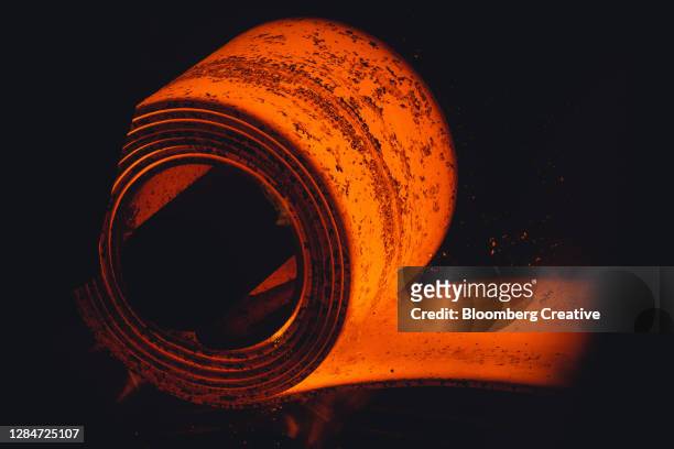 a steel coil at a foundry - iron roll stockfoto's en -beelden