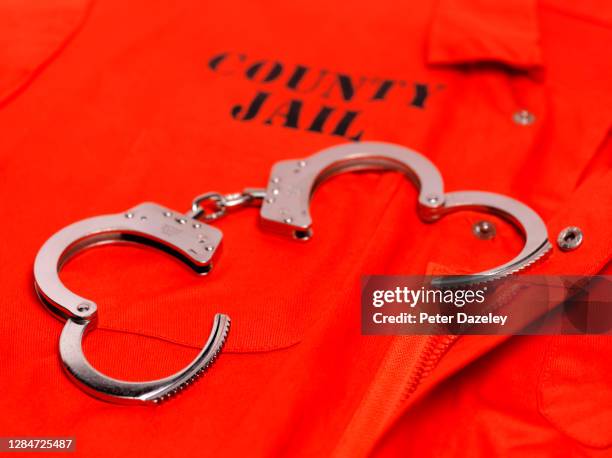 county jail jumpsuit with handcuffs - prison jumpsuit stock pictures, royalty-free photos & images