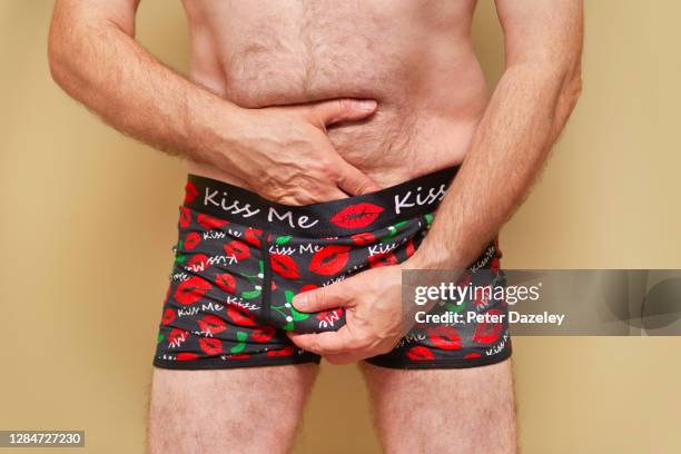 man checking himself in christmas underwear - genital herpes stock pictures, royalty-free photos & images