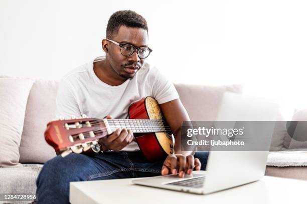 you're not a musician until you've written a breakup song - black guitarist stock pictures, royalty-free photos & images