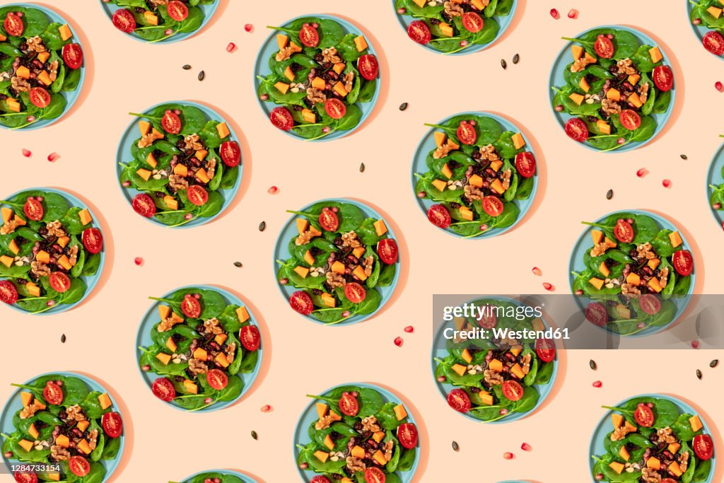 Pattern of plates of fresh ready-to-eat vegan salad