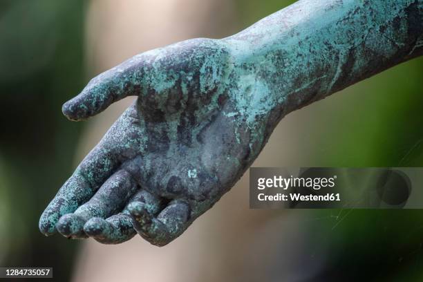 weathered arm of bronze statue - bronze statue stock pictures, royalty-free photos & images