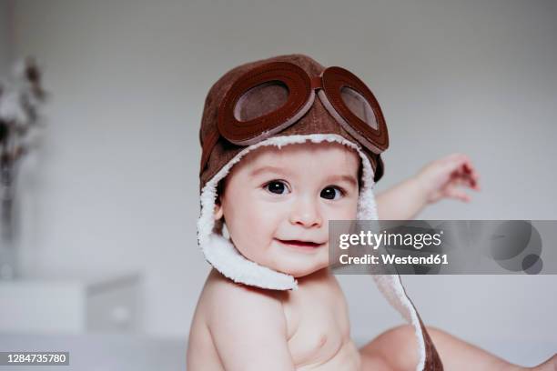 cute baby boy wearing aviator cap while sitting at home - aviation hat 個照片及圖片檔