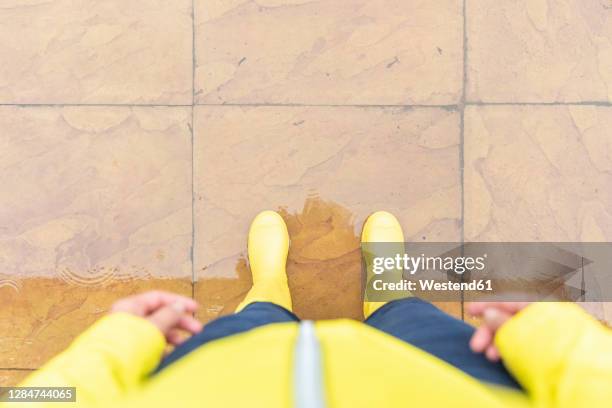 woman standing on tiled floor in back yard - pov shoes stock-fotos und bilder