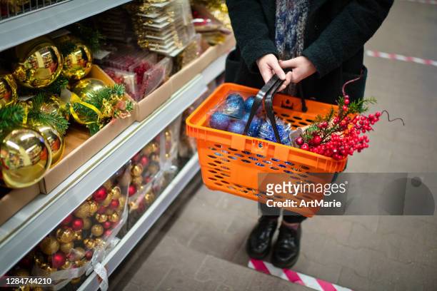 social distancing on christmas shopping during covid-19 - christmas decorations in store stock pictures, royalty-free photos & images