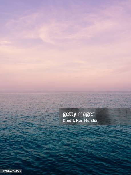 textures and ripples mix with a colourful sky in menton france - stock photo - costa azul fotografías e imágenes de stock
