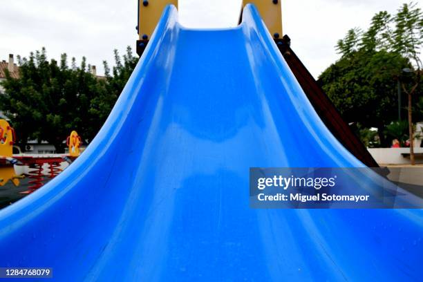 blue slide in the playground - rutsche stock-fotos und bilder
