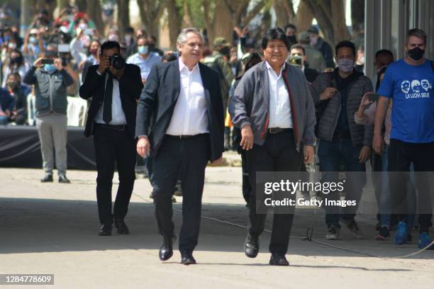 President of Argentina Alberto Fernandez escorts Former president of Bolivia Evo Morales as he crosses the border between Bolivia and Argentina after...