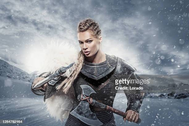 beautiful blonde weapon wielding female viking warrior queen - machado imagens e fotografias de stock