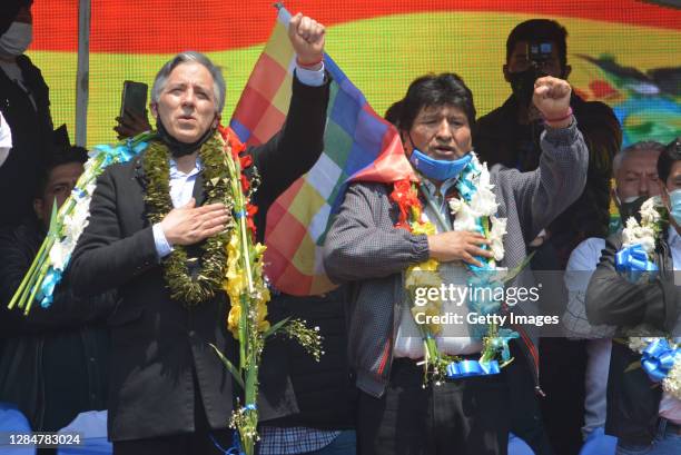 Former president of Bolivia Evo Morales and former vice president of Bolivia Alvaro Garcia Linera greet supporters during a welcoming ceremony for...