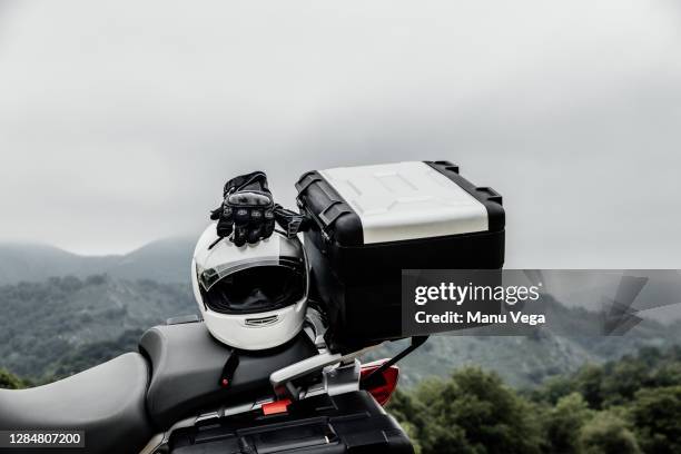 helmet and gloves on a parked adventure motorcycle - stock photo - motorcycle travel stock pictures, royalty-free photos & images