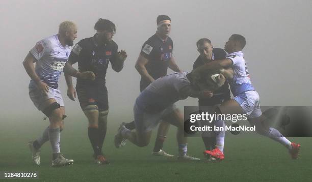 Nathan Chamberlin of Edinburgh is tackled by Ben Thomas of Cardiff Blues during the Guinness PRO14 match between Edinburgh Rugby and Cardiff Blues at...