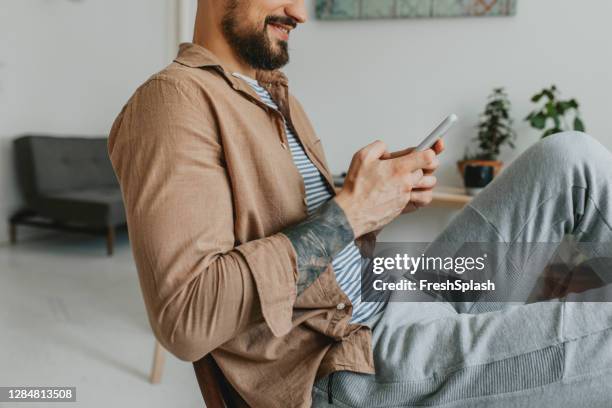 anonymous young man chatting on social media - a close up - jogging pants stock pictures, royalty-free photos & images