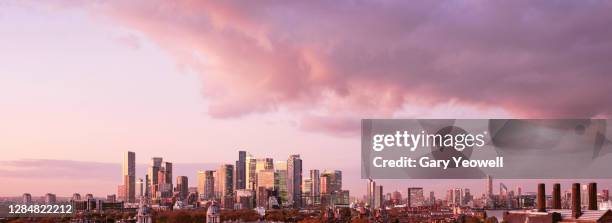 elevated view over london city canary wharf skyline at sunset - sunset on canary wharf stock-fotos und bilder