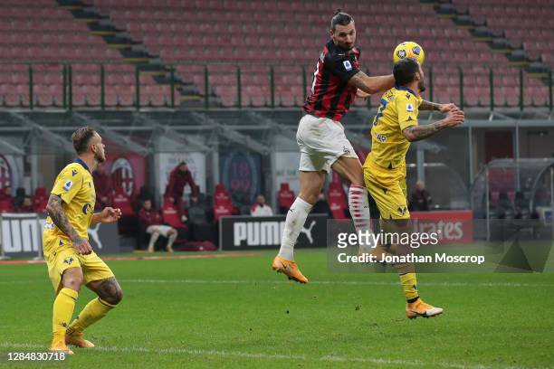 Zlatan Ibrahimovic of AC Milan heads the ball onto his own arm in the lead up to Davide Calabria's goal which was subsequently ruled out for the...