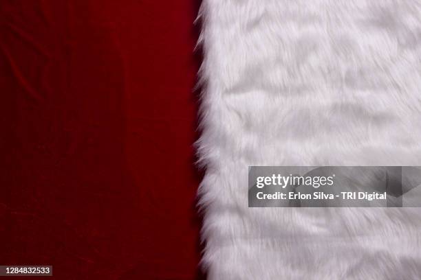 background divided into wet velvet and furry fabric reminiscent of a christmas atmosphere - fake fur stock pictures, royalty-free photos & images