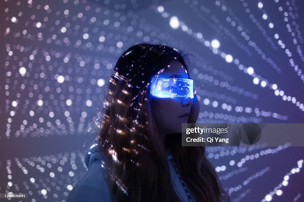 Woman wearing augmented reality glasses at night