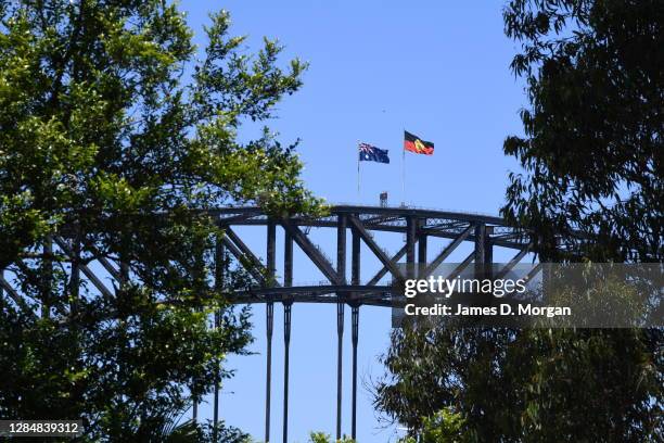 The Australian Aboriginal flag flies atop the Sydney Harbour Bridge alongside the Australian National flag in respect of NAIDOC week on November 10,...