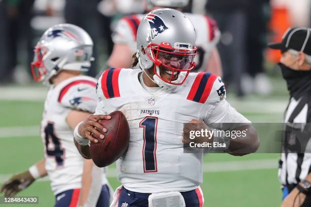 Cam Newton of the New England Patriots reacts after scoring a game-tying touchdown during the second half against the New York Jets at MetLife...