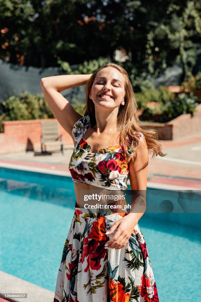 Elegant woman wearing a fashionable floral long dress