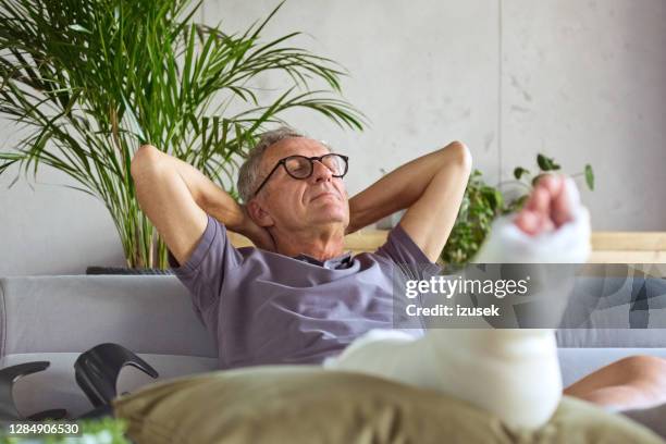 senior man with broken leg at home - sleepers cast stock pictures, royalty-free photos & images