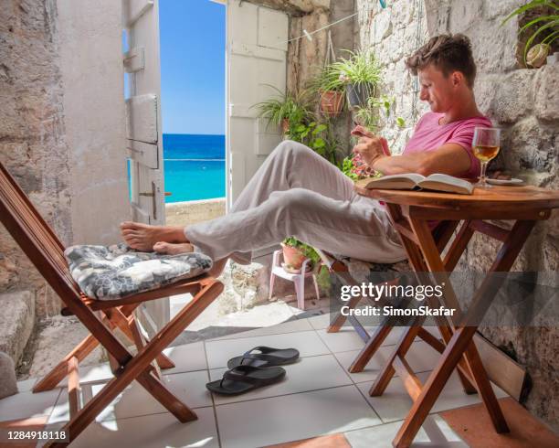 young man enjoying the summertime by the sea - croatia tourist stock pictures, royalty-free photos & images