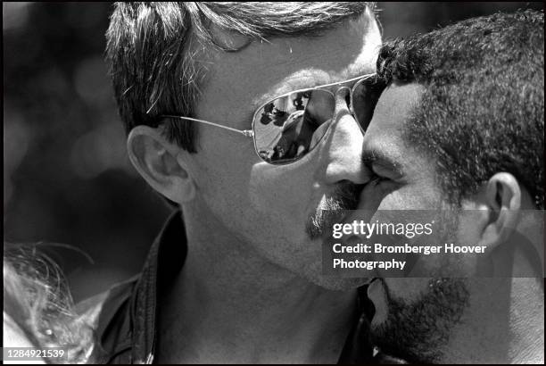 Close-up of a man in mirrored sunglasses as he kisses another man, outside the Civic Center during the International Lesbian & Gay Freedom Day...