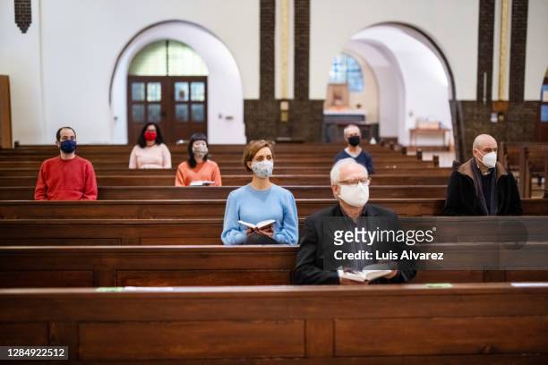 group of people at church congregation during pandemic - godsdienstige gebouwen stockfoto's en -beelden