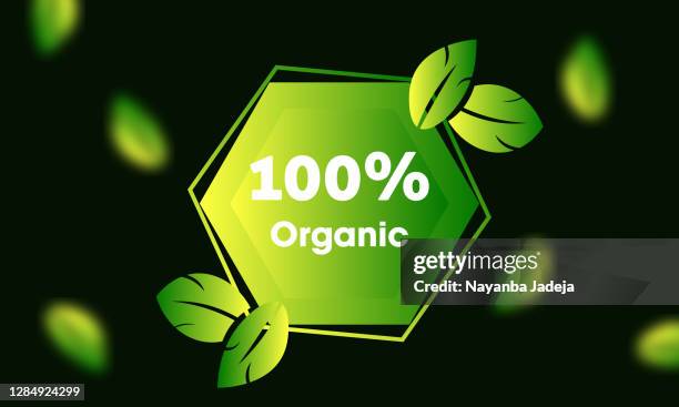 100% organic badge with green leaves - biodegradable stock illustrations