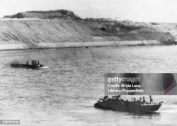 Egyptian soldiers arrive at the East Bank of the Suez Canal, during the Yom Kippur War, aka the Fourth Arab-Israeli War, 6th October 1973. The boat...