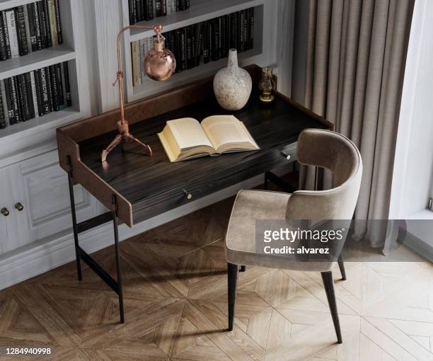 digital image close up of a chair and desk with an open book - modern chair stock pictures, royalty-free photos & images